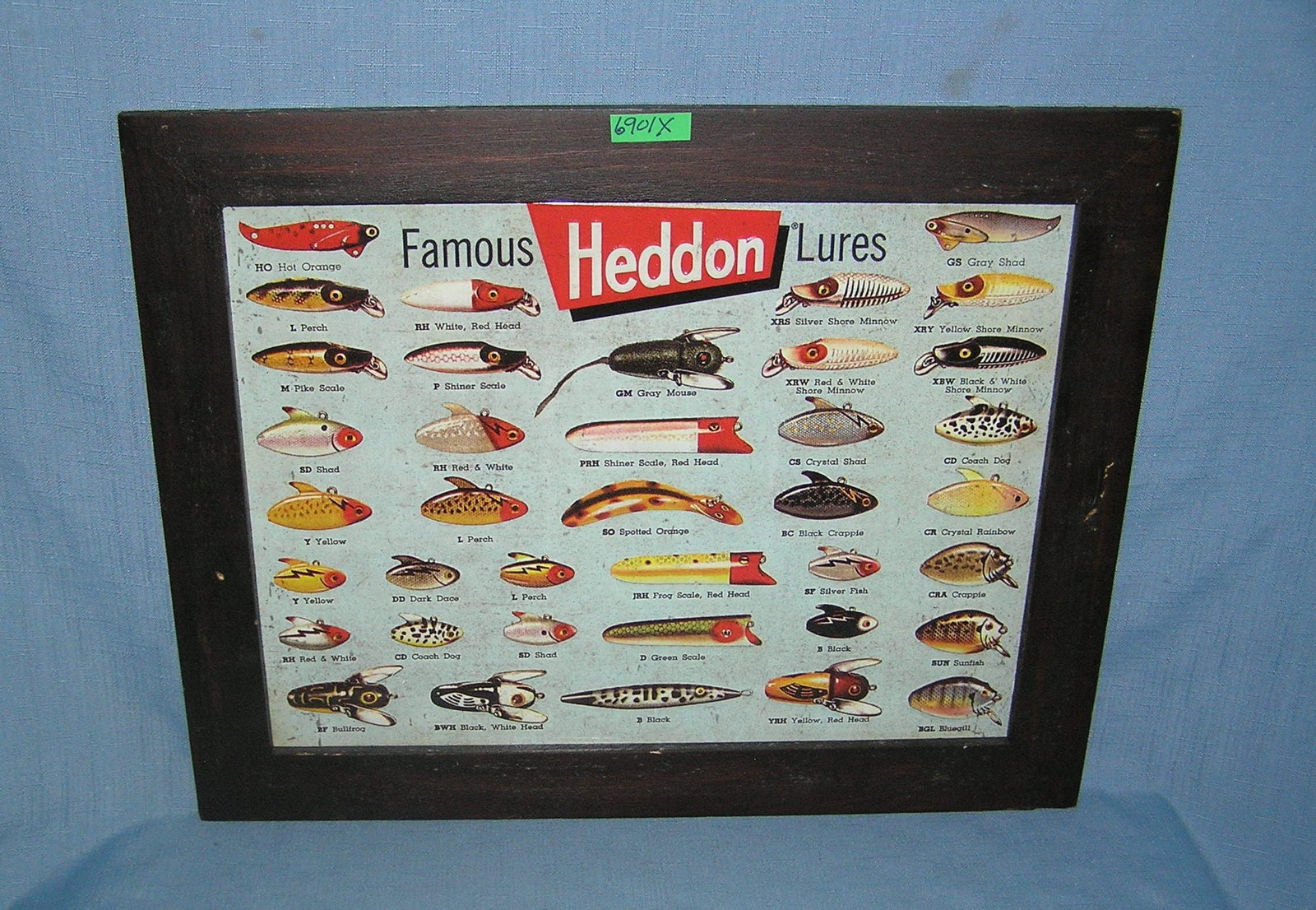 Heddon Famous Lures all metal and wood framed advertising sign: Heddon Famous Lures all metal and wood framed advertising sign est. value $65.00-$75.00