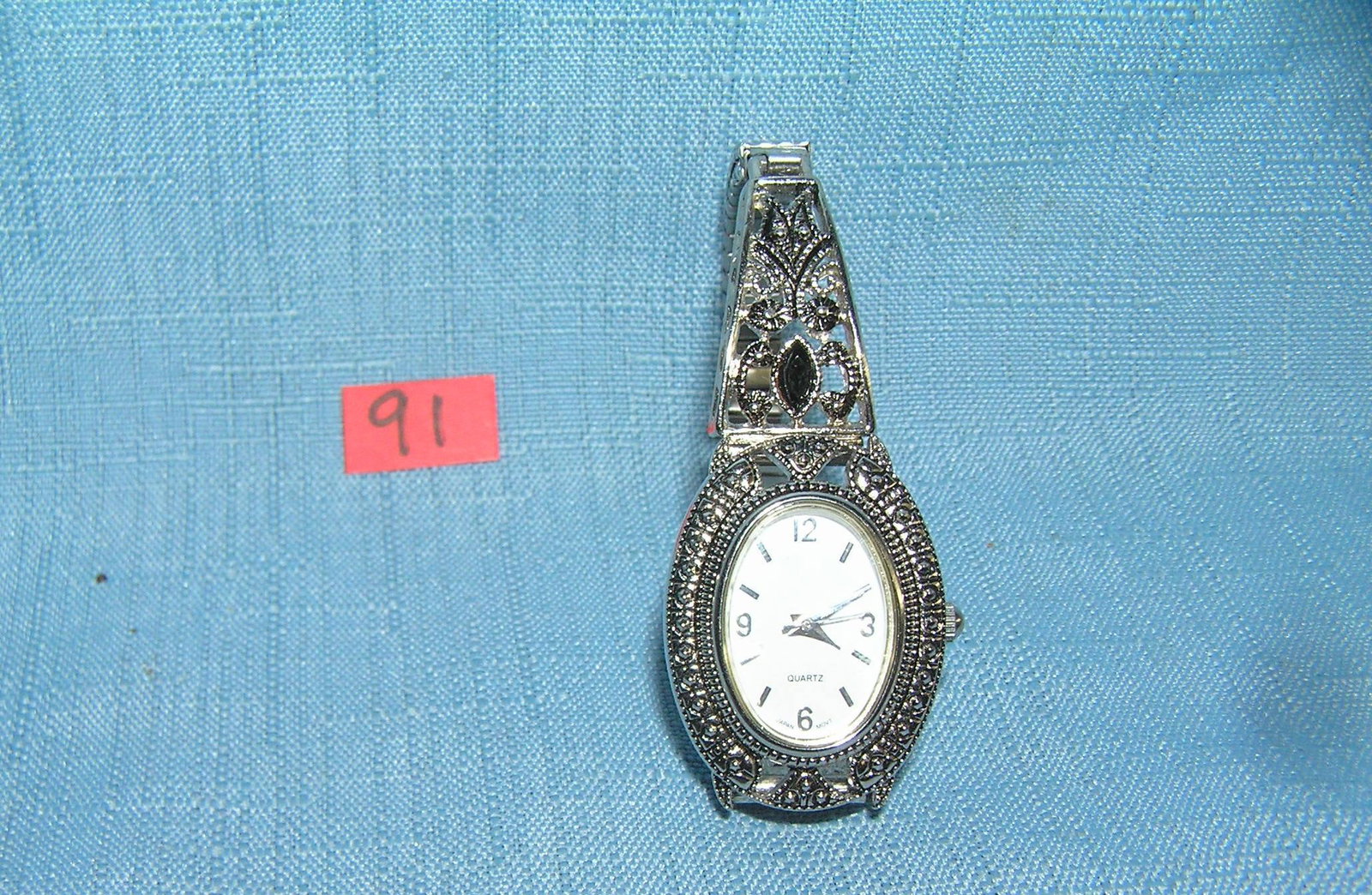 Fancy silver toned ladies' wrist watch: Fancy silver toned ladies' wrist watch with 2 onyz stones in band est. value $40.00-$50.00