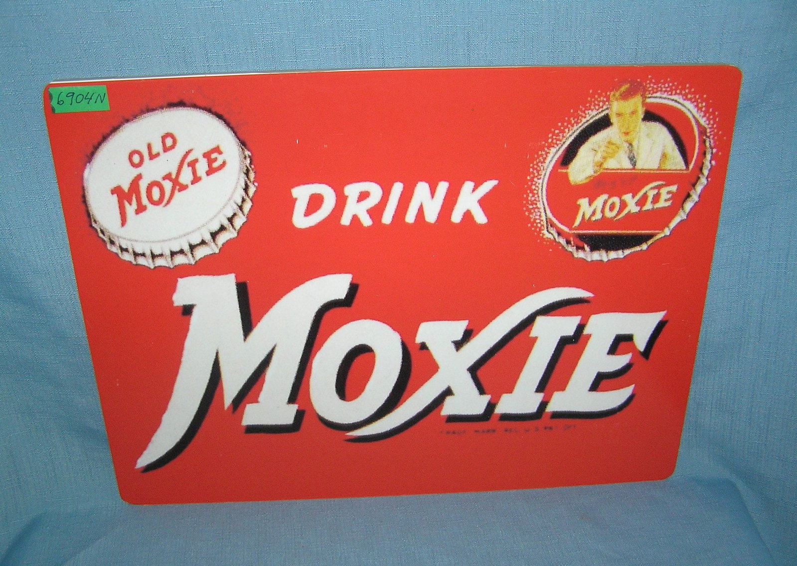 Drink moxie retro style advertising sign: Drink movie retro style advertising sign printed on PVC hardboard these signs are auctioned for their decorative and display purposes 12 inches by 16 inches est. value $50.00-$60.00