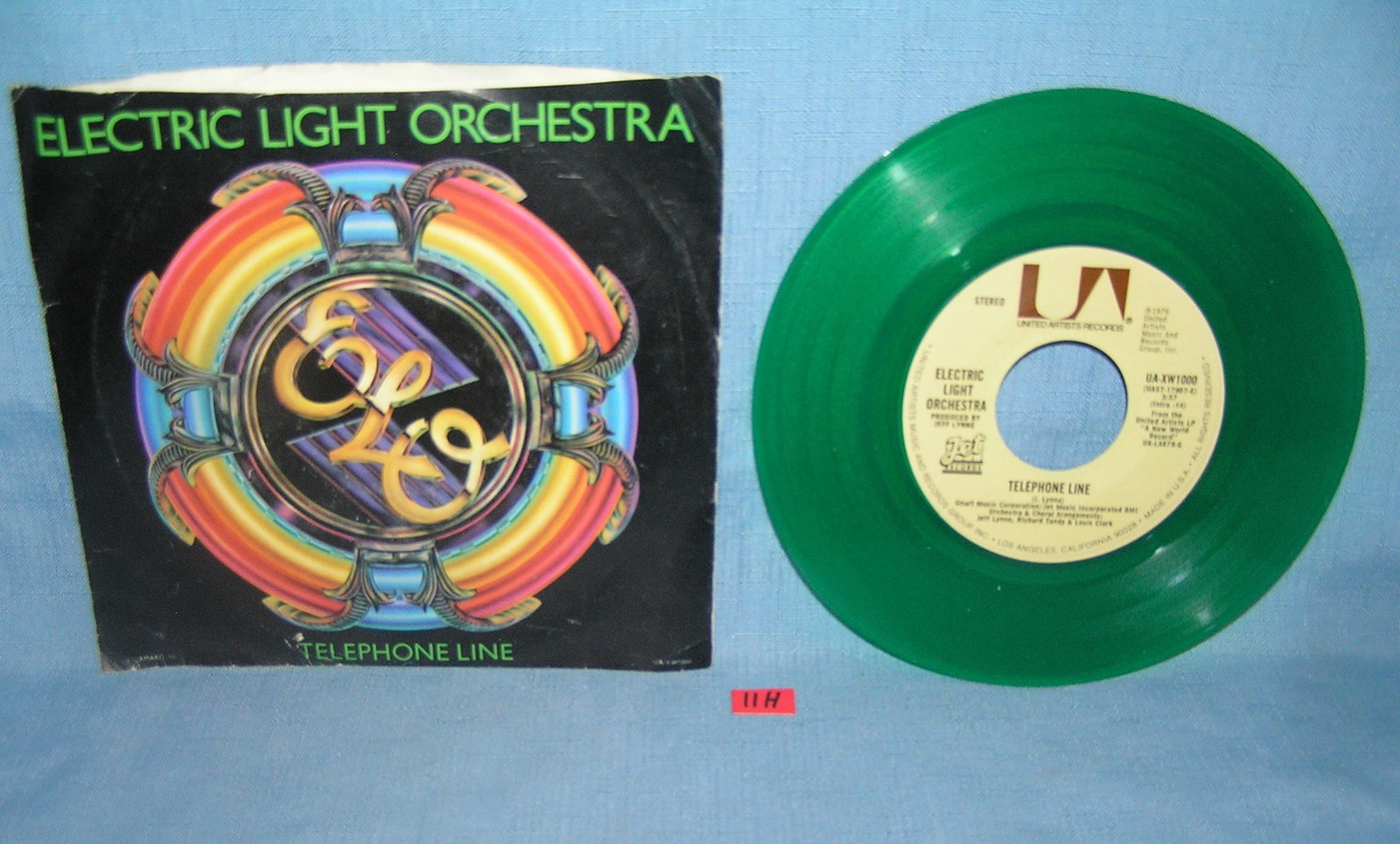 Electric Light Orchestra green vinyl 45 rpm record: Electric Light Orchestra vintage green vinyl 45 rpm record and picture sleeve titles: telephone line and Poor Boy excellent condition est. value $35.00-$45.00