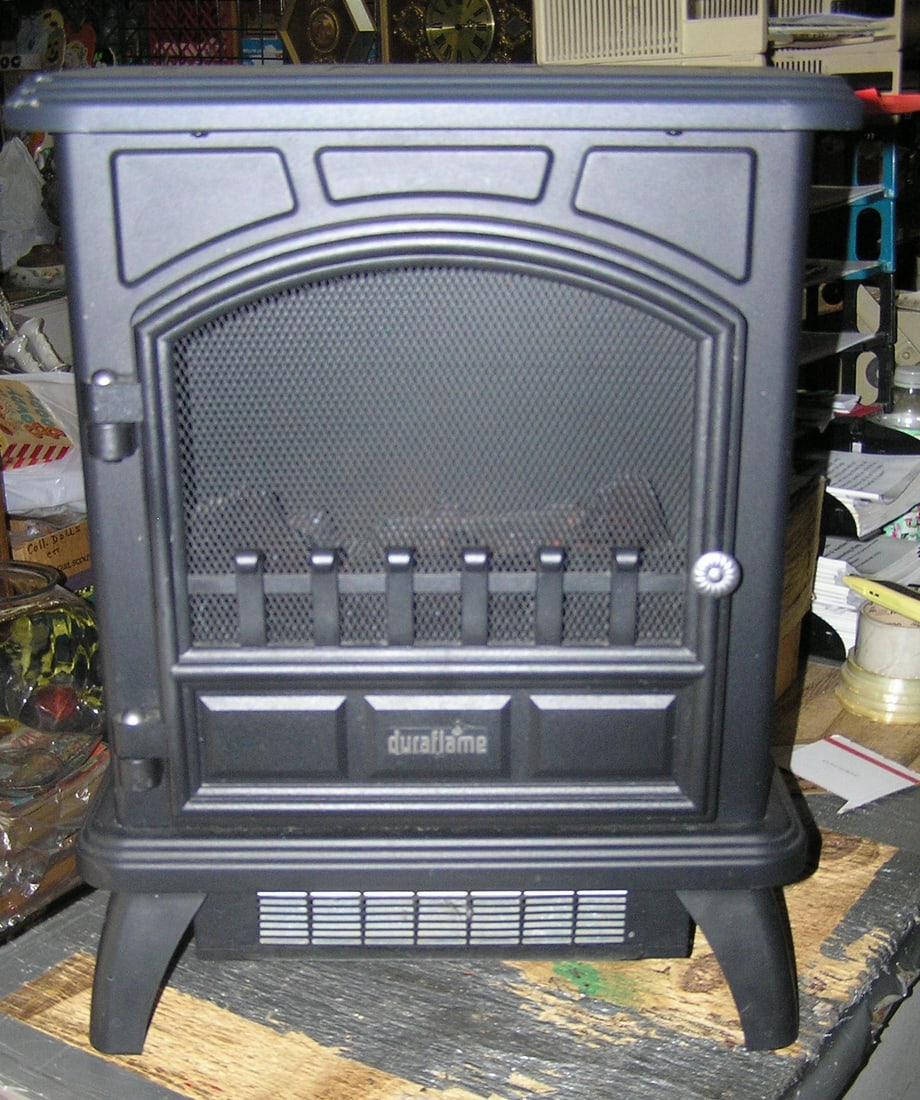 Duraflame stove shaped space heater: Duraflame stove shaped space heater with realistic illuminated fireplace flame est. value $175.00-$200.00