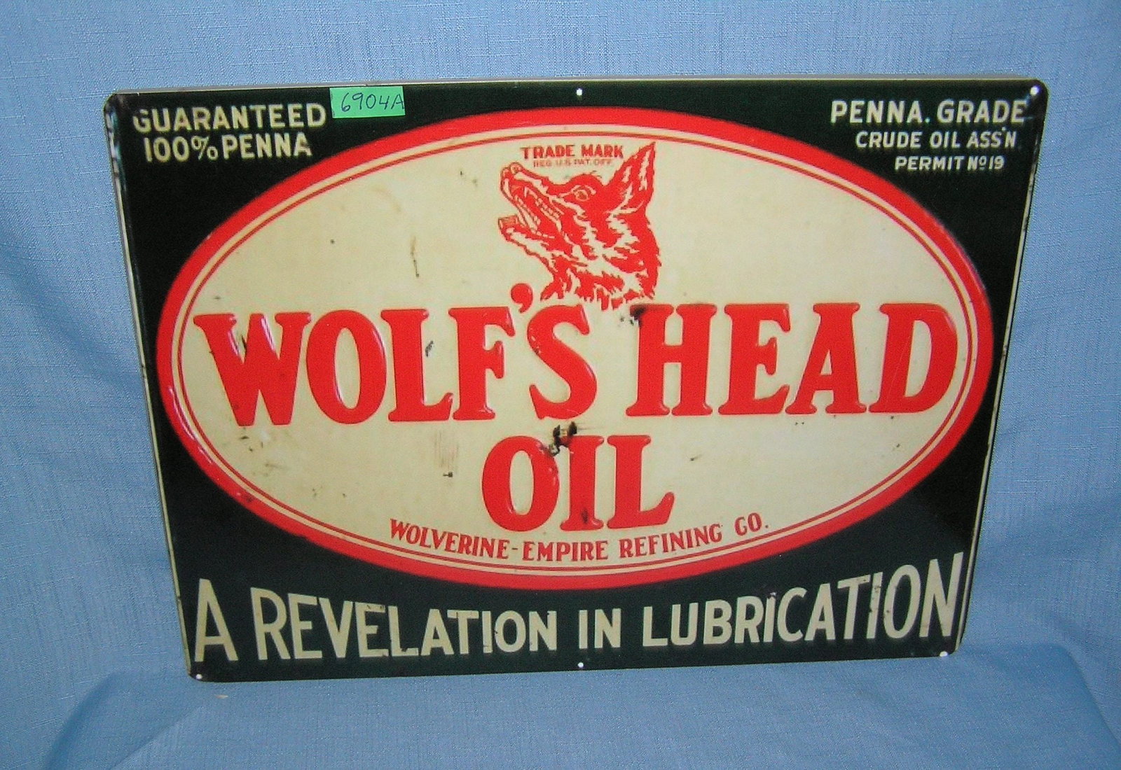 Wolfs Head Oil retro style advertising sign: Wolfs Head Oil retro style advertising sign printed on PVC hardboard these signs are auctioned for their decorative and display purposes 12 inches by 16 inches est. value $50.00-$60.00