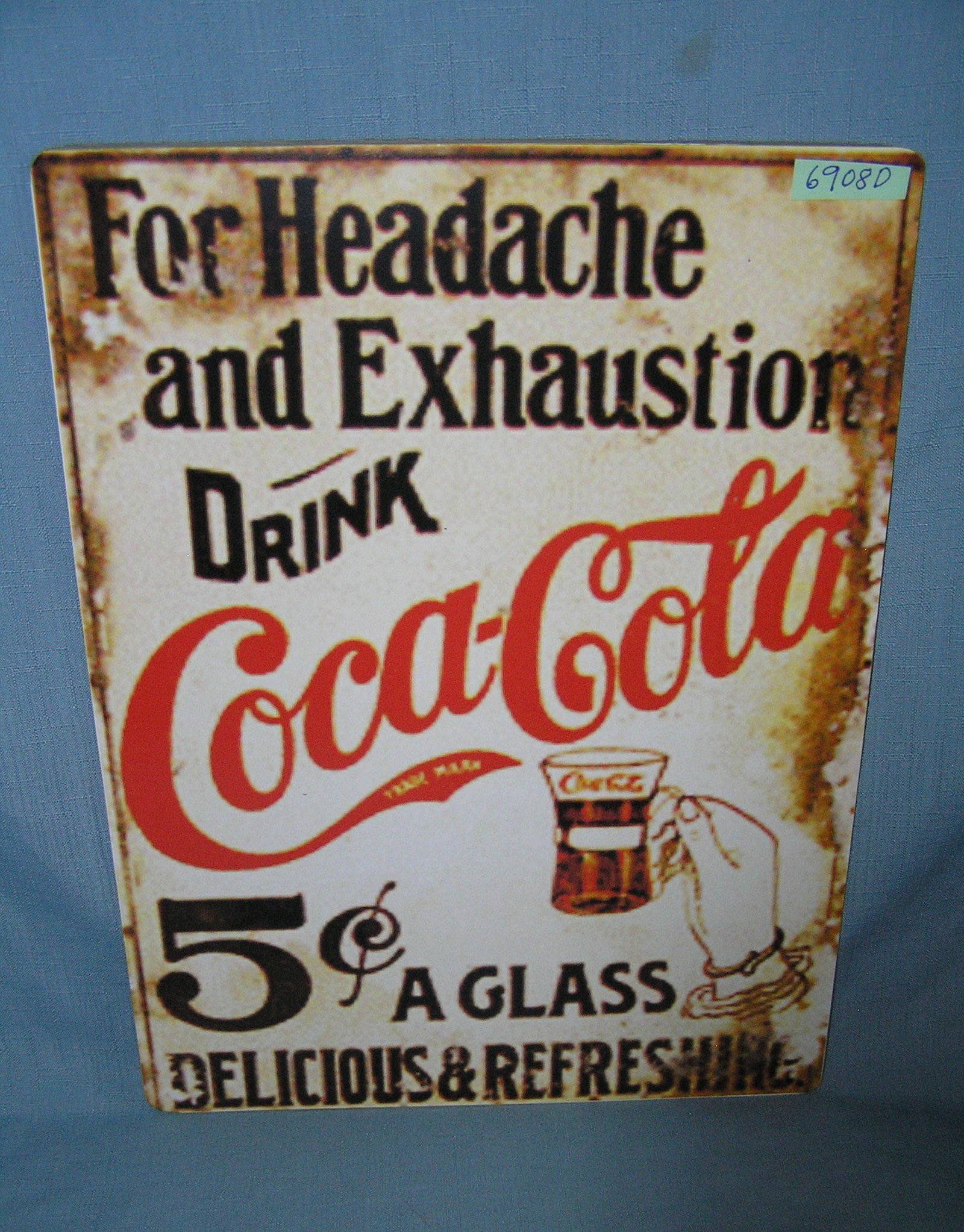 For headache and exhaustion drink Coca Cola style advertising sign: For headache and exhaustion drink Coca Cola style advertising sign printed on PVC hardboard these signs are auctioned for their decorative and display purposes 12 inches by 16 inches est. value $40.00