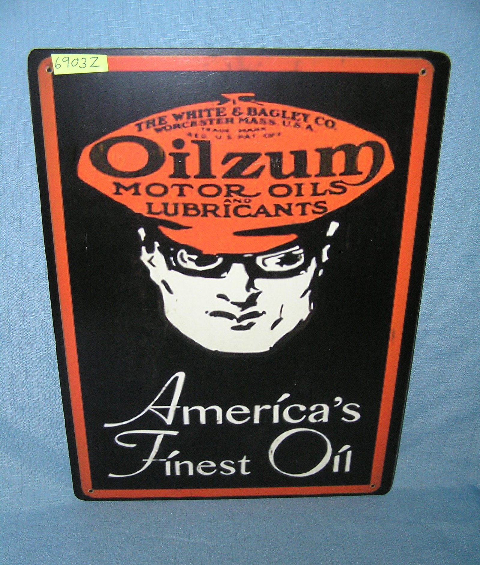 Oilzum America's finest oil retro style advertising sign: Oilzum America's finest oil retro style advertising sign printed on PVC hardboard these signs are auctioned for their decorative and display purposes 12 inches by 16 inches est. value $50.00-$60.00