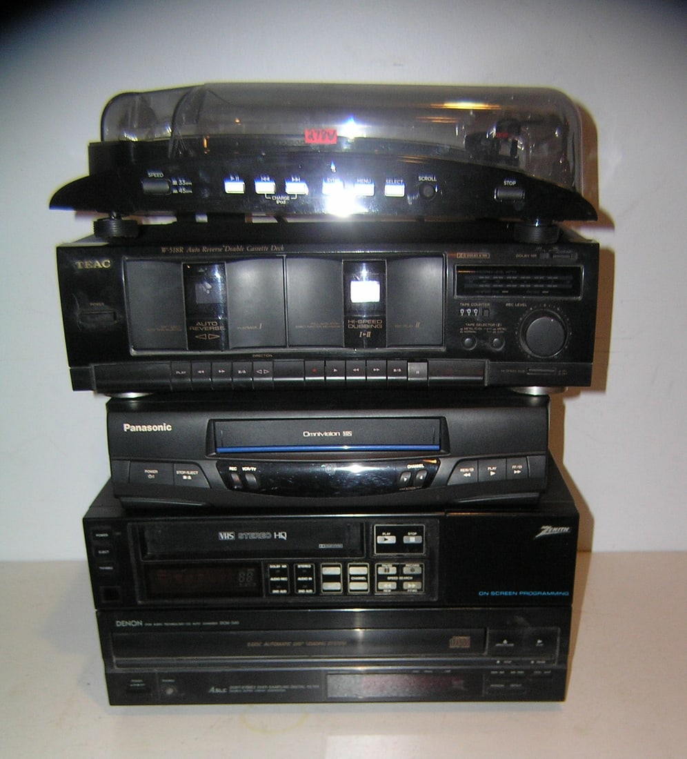 Group of modern electronics: Group of modern electronics includes Ion I Profile turn table, Teac auto reverse double cassette deck, Denon automatic disc loading system, Zenith onscreen programing VHS stereo an dPan asonic omnivis