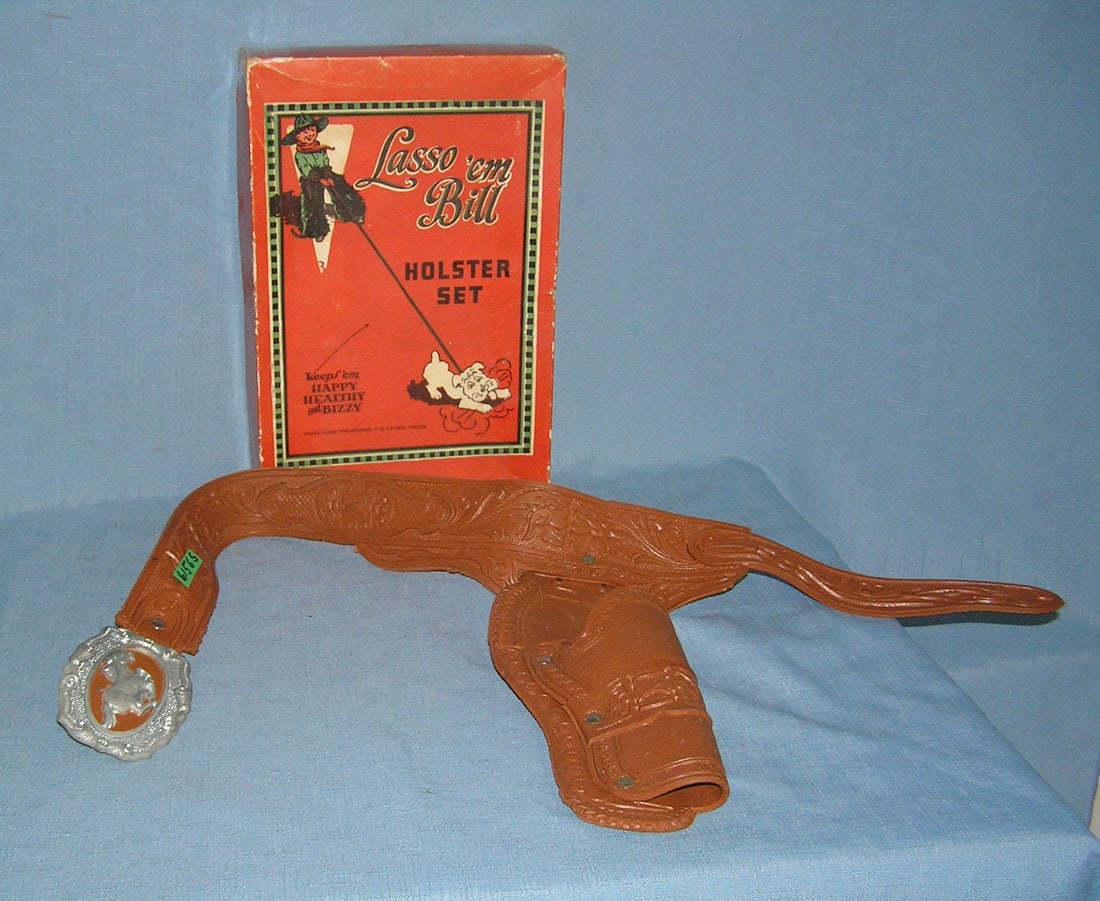 Vintage cap gun holster, belt buckle with pictural box: Vintage western themed cap gun holster and belt buckle with pictural display box est. value $125.00-$150.00