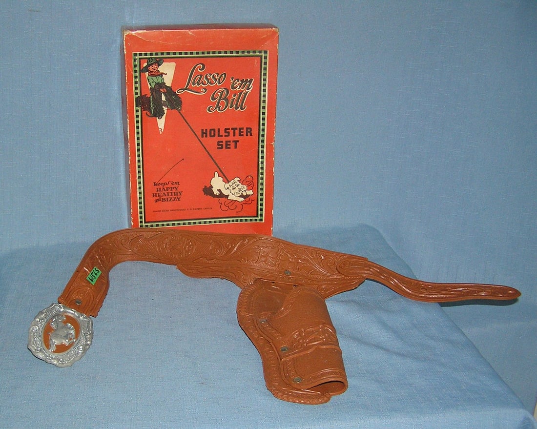 Vintage cap gun holster, belt buckle with pictural box: Vintage western themed cap gun holster and belt buckle with pictural display box est. value $125.00-$150.00