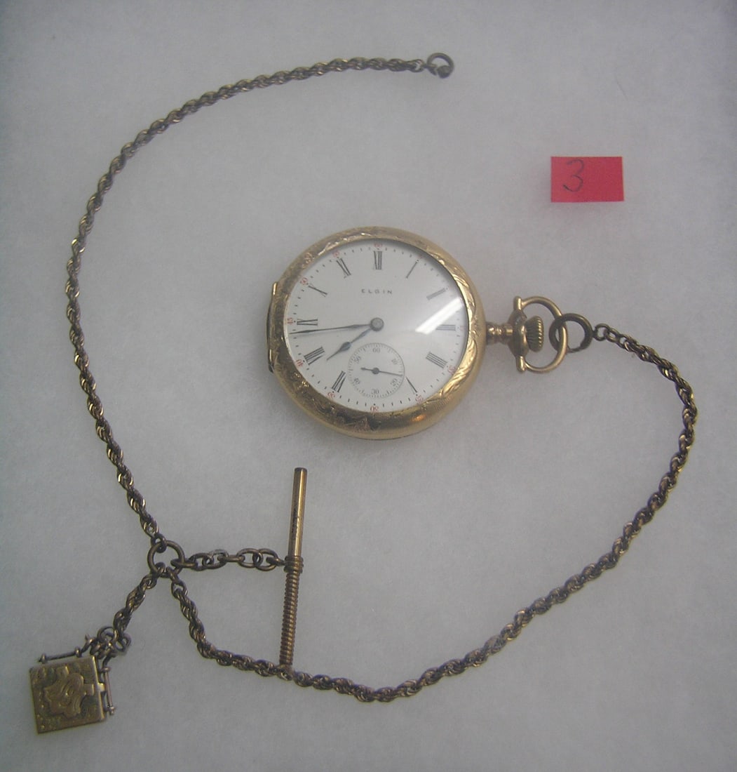 Antique Elgin pocket watch: Antique Elgin pocket watch with minuite and second hand dials in gold filled case, 15 jewels, case dated 1909 with baby photo watch, also has watch chain and locket fob est. value $500.00-$600.00
