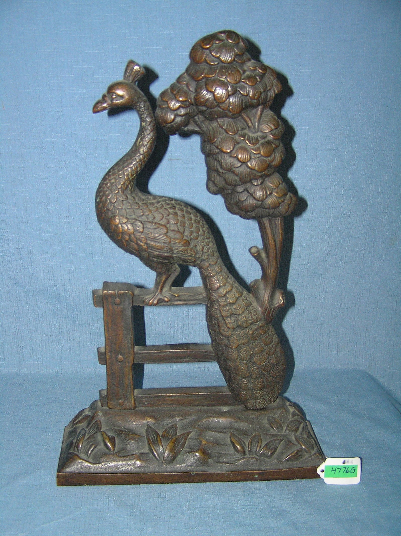 Large bronze peacock seated on fence door stop: Large bronze peacock seated on fence door stop with weighted base circa early 1900s est. value $1400.00-$1500.00