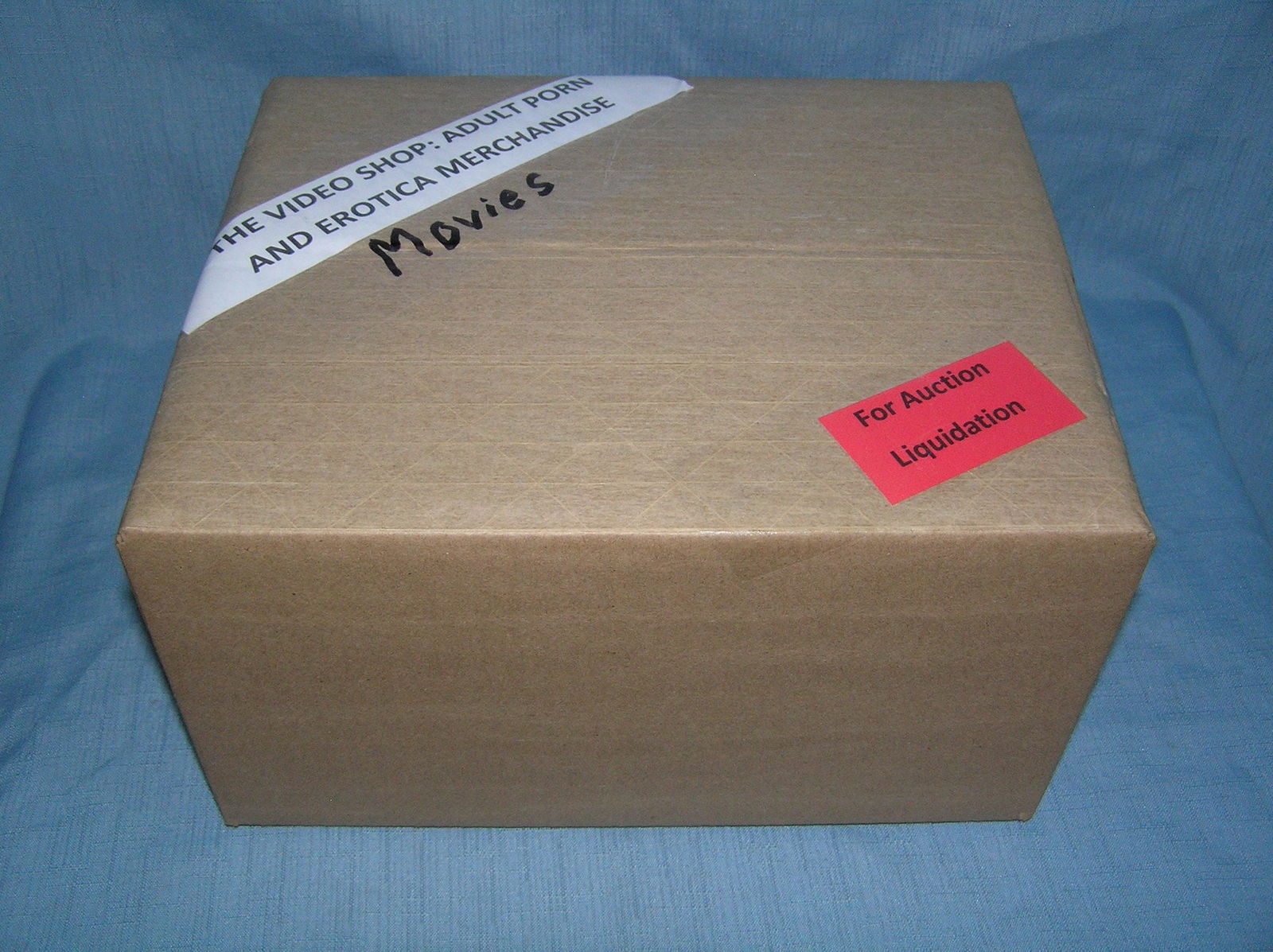Moving and Storage Company mystery box lot marked The Video Shop: Moving and Storage Company mystery box lot marked The Video Shop: Adult Porn and Erotica Movies part of a moving and storage company seized or unclaimed merchandise group sent to auction for liquidati