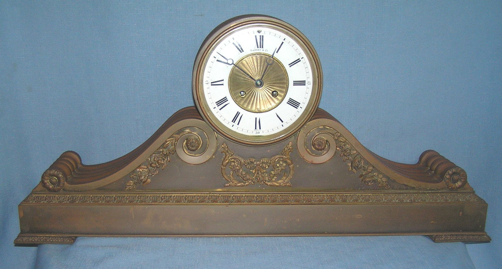 Great early Tiffany and Co. bronze mantle clock: Great early Tiffany and Co. bronze mantle clock decorated with floral and leaf motif with applied bronze feet, clock works, porcelain face made in France, this great high end Tiffany and company piece