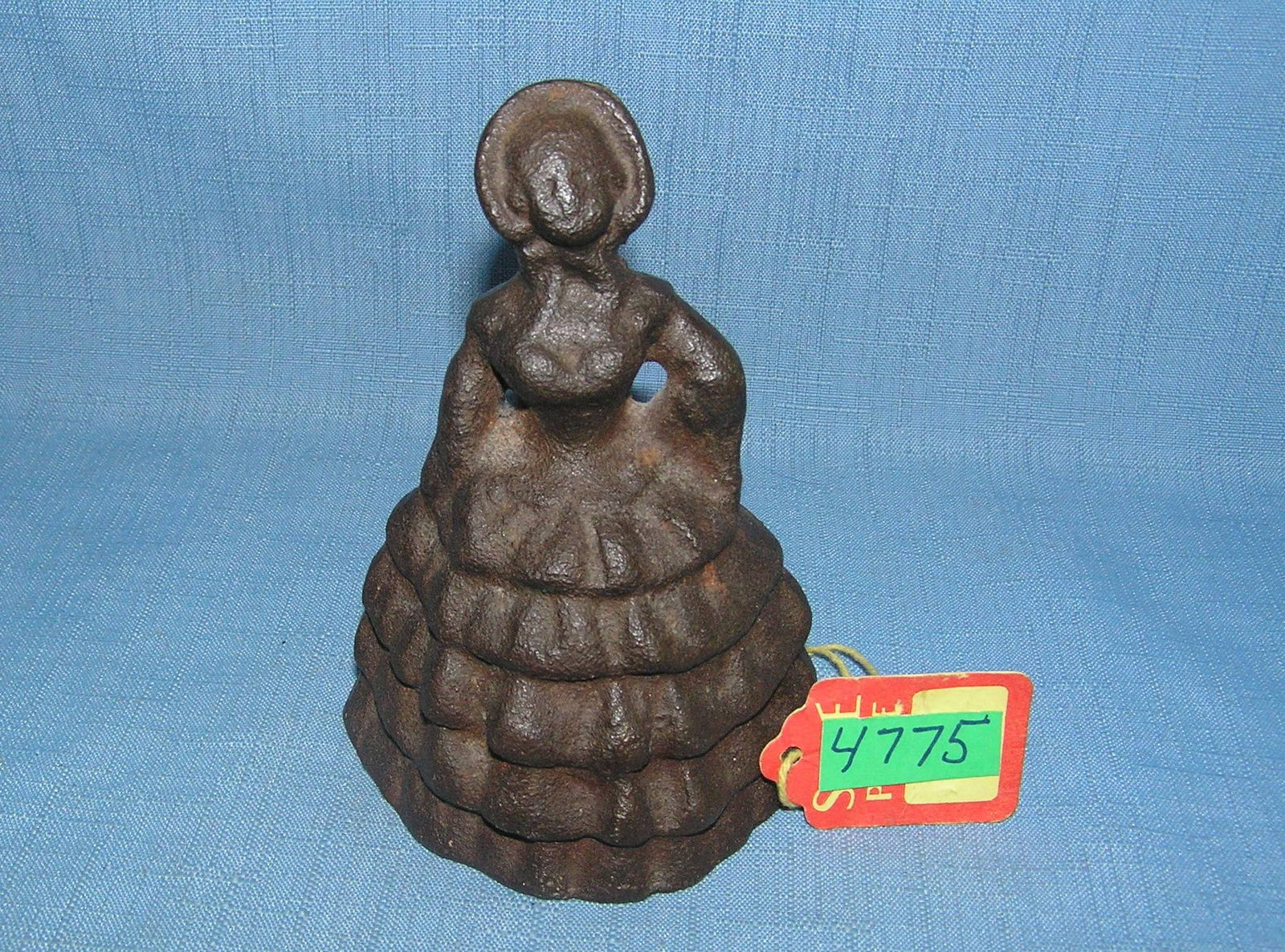 Cast iron woman doorstop with long dress and bonnet: Cast iron woman doorstop with long dress and bonnet est. value $75.00-$80.00