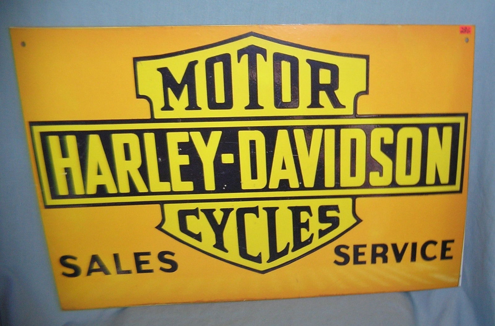 Antique style retro Harley Davidson advertising sign: Antique style retro Harley Davidson motorcycle sales and service advertising sign mounted on masonite est. value $200.00-$250.00