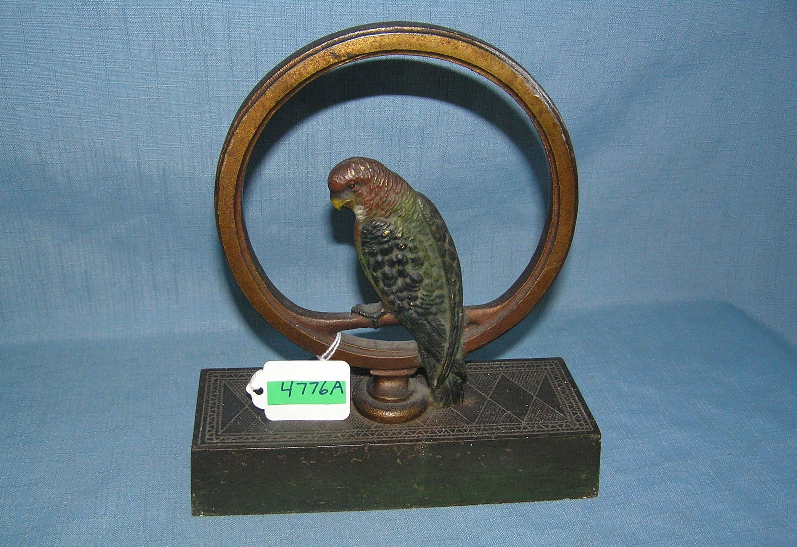 Hand painted cast iron parrot seated in ring door stop circa 1930s: Hand painted cast iron parrot seated in ring door stop circa 1930s est. value $400.00-$45.000