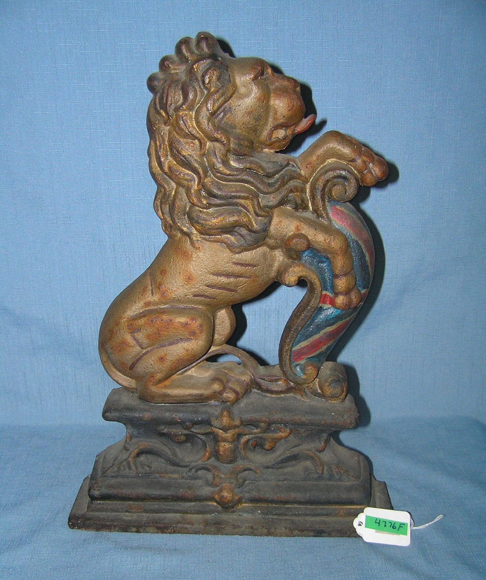 Hand painted cast iron heraldic lion door stop: Hand painted cast iron heraldic lion door stop with Union Jack crest mounted on base circa early 1900s est. value $1100.00-$1200.00