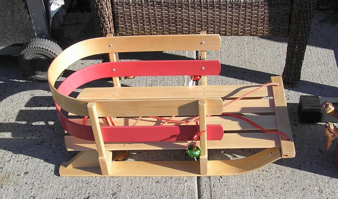 Child's sled complete with ribbons and bells: Holiday decorated child's sled complete with ribbons and bells like new condition est. value $75.00-$100.00