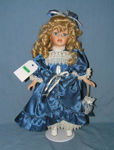 Fancy porcelain doll with silk dress: Fancy porcelain doll with silk dress est. value $75.00-$100.00