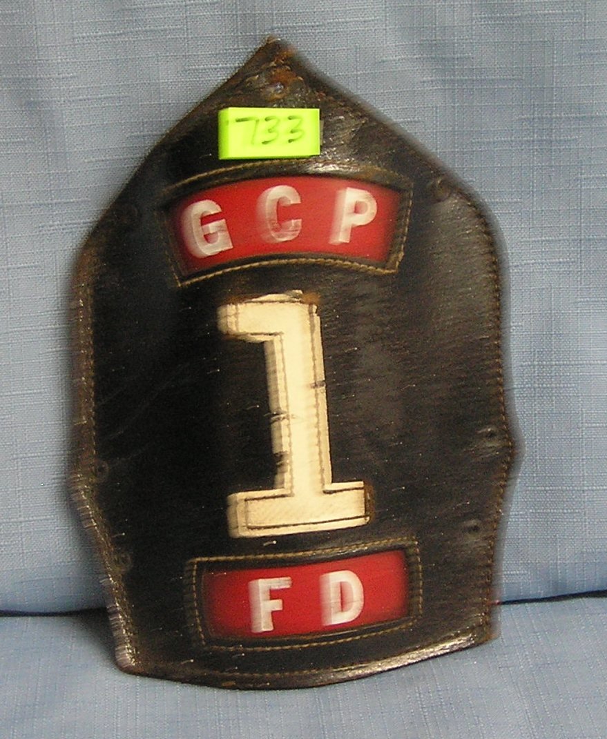 Antique fire helmet shield: Antique fire helmet shield $40.00-$50.00
