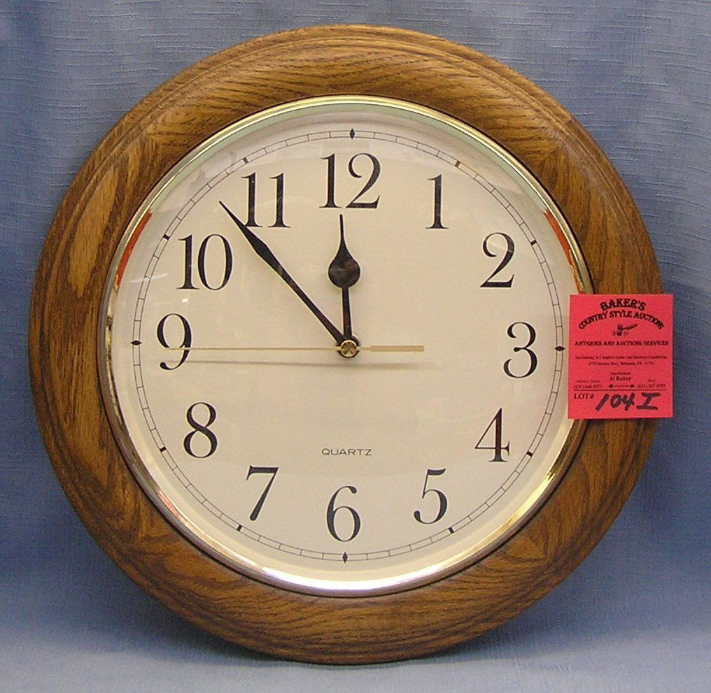 Modern oak quartz wall clock: Modern oak quartz wall clock est. value $25.00-$30.00