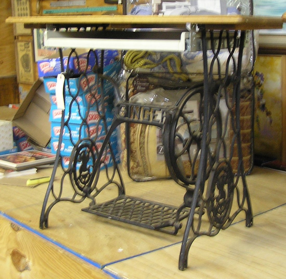 Antique cast iron Singer sewing machine cabinet base: Antique cast iron Singer sewing machine cabinet base converted to computer desk with oak top and slide out keyboard drawer est. value $125.00-$150.00