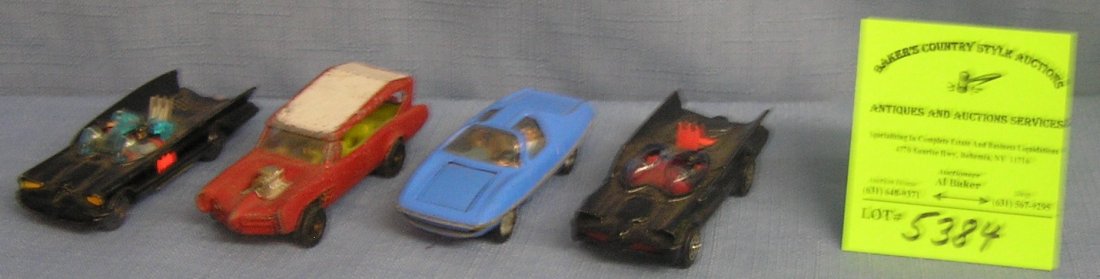 Group of four vintage all cast metal character vehicles: Group of four vintage all cast metal character vehicles includes batmobiles, monkey mobile and the Man From Uncle car $250.00-$300.00