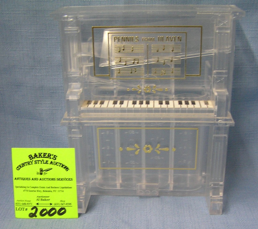 Lucite piano shaped coin bank: Lucite piano shaped coin bank est. value $25.00-$30.00