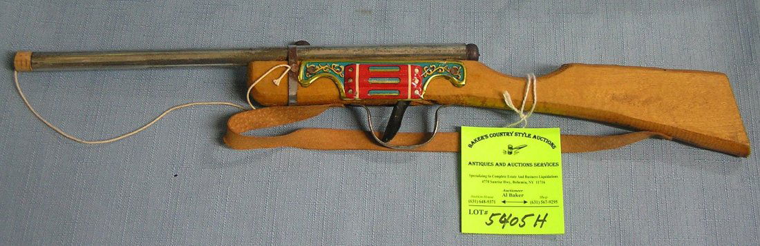 Early tin and wood cork pop gun new old stock never: Early tin and wood cork pop gun new old stock never played with $35.00-$45.00