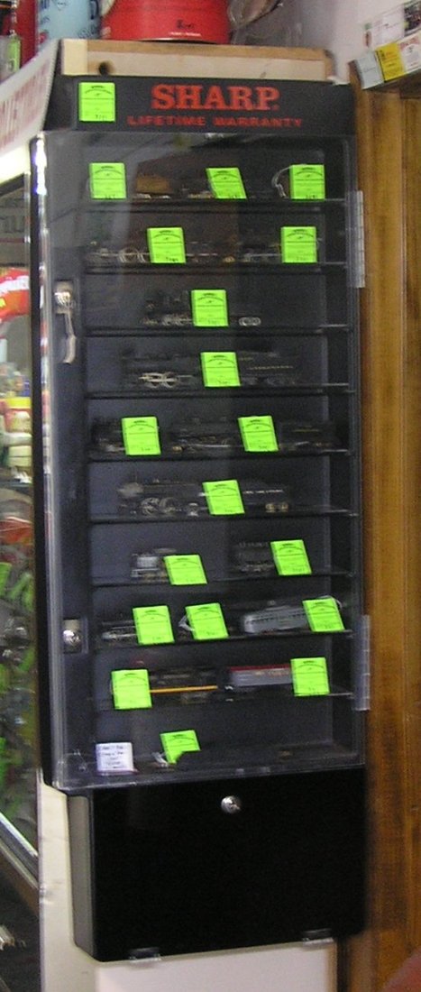 Vintage Sharp wristwatch display case: Vintage Sharp wristwatch display case 10 shelf capacity with dual locks comes with two keys great for toy trains and collectibles one corner on front door as found est. value $150.00-$200.00