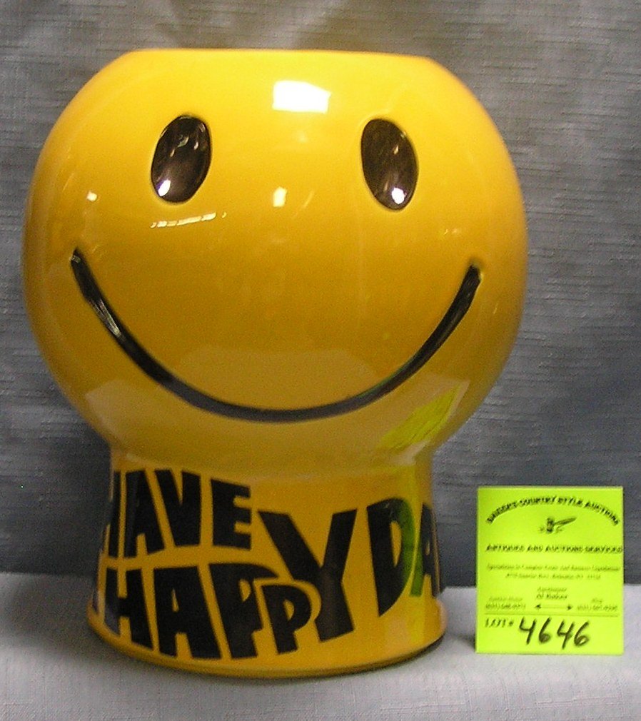 The smiling face have a happy day cookie jar by McCoy: The smiling face have a happy day cookie jar by McCoy condition as found crack around front of face $25.00-$35.00