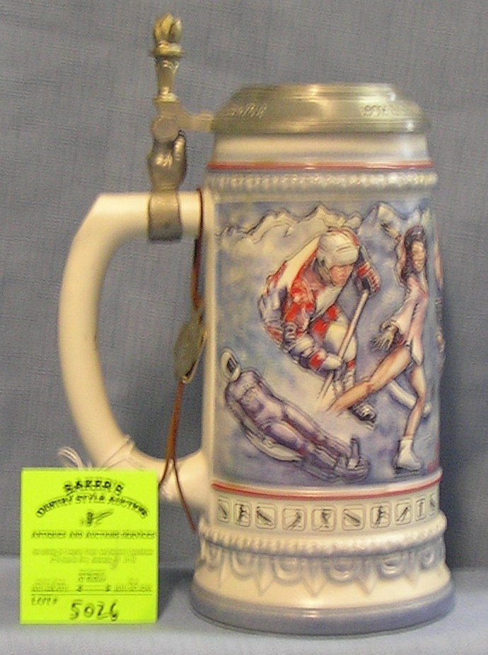 Vintage US Winter Olympic games Team beer stein: Vintage 1992 US Winter Olympic games Team beer stein from Albertville France. Stein made in Germany with pewter cover with USA and Olympic rings upper thumb opener features the Olympic torch mint cond