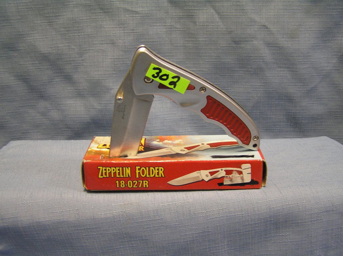 Red zeppelin folding pocket knife with original box: Red zeppelin folding pocket knife with original box est. value $30.00-$40.00