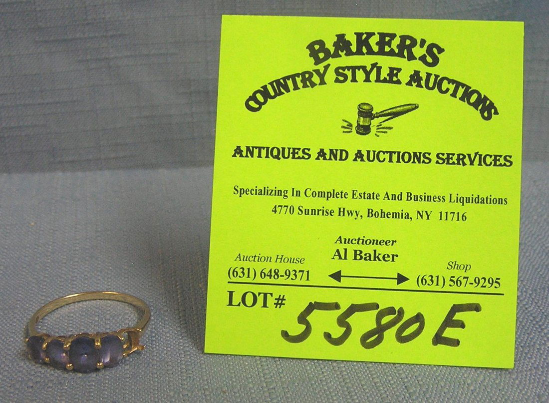 Vintage yellow gold and tanzinite multi stone ring: Vintage yellow gold and tanzinite multi stone ring note one stone missing $50.00-$75.00