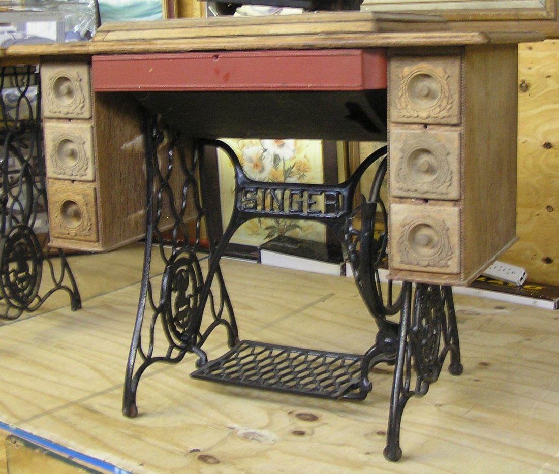Antique oak Singer sewing machine cabinet: Antique oak Singer sewing machine cabinet with wrought iron base circa early 1900’s est. value $125.00-$150.00