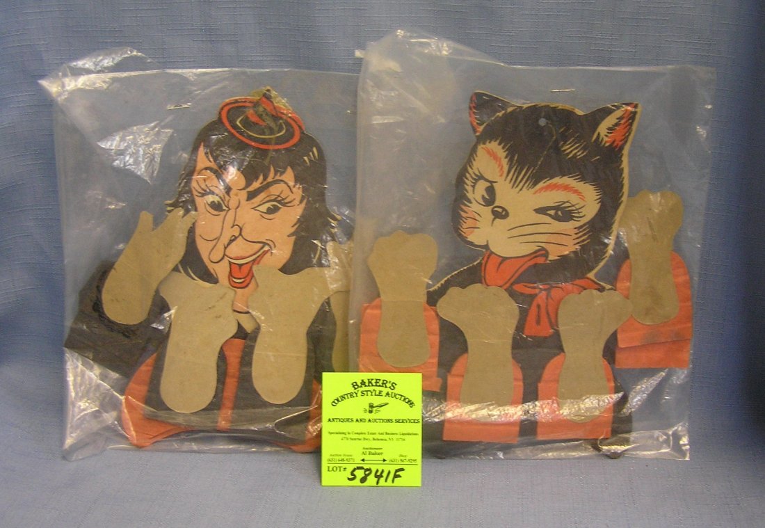 Pair of vintage die cut Halloween decorations: Pair of vintage die cut Halloween decorations featuring a cat and a witch est. value $40.00-$60.00