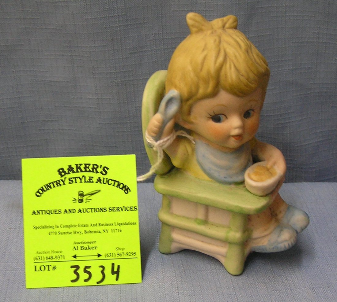 Vintage child in high chair eating cereal porcelain: Vintage child in high chair eating cereal porcelain figurine est. value $25.00-$30.00