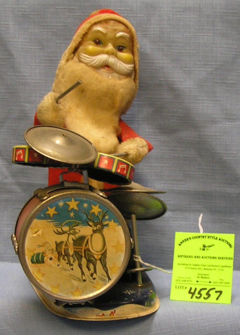 Santa Claus playing the drums batt. op. mechanical toy: Great early all tin mechanical Santa Claus playing the drums battery operated mechanical toy with light up eyes Alps Toys circa 1950’s $350.00-$400.00