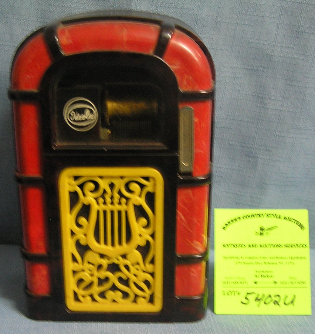 Early Ideal Ideola windup mechanical musical Bakelite: Early Ideal Ideola windup mechanical musical Bakelite jukebox bank extremely rare $250.00-$300.00