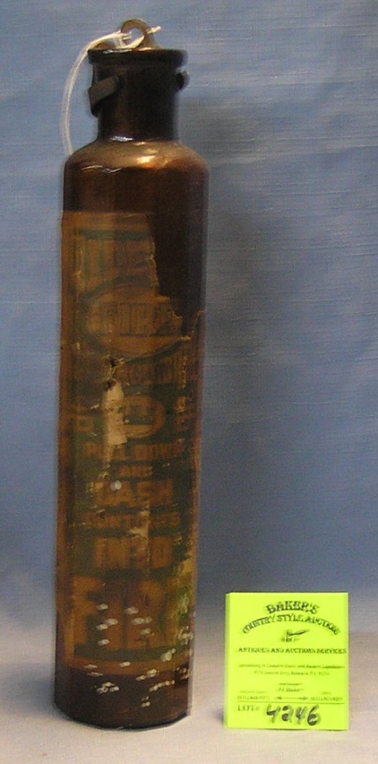 Antique brown glass fire extinguisher: Antique brown glass fire extinguisher with original label and cap circa early 1900’s $125.00-$150.00