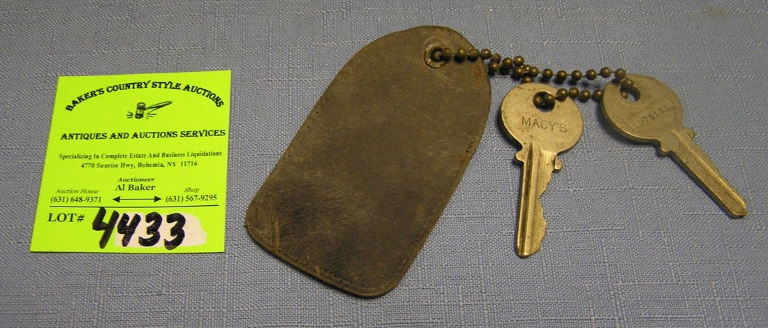 Pair of early Macy’s department store keys circa 1940’s: Pair of early Macy’s department store keys circa 1940’s with leather keychain holder est. value $40.00-$50.00