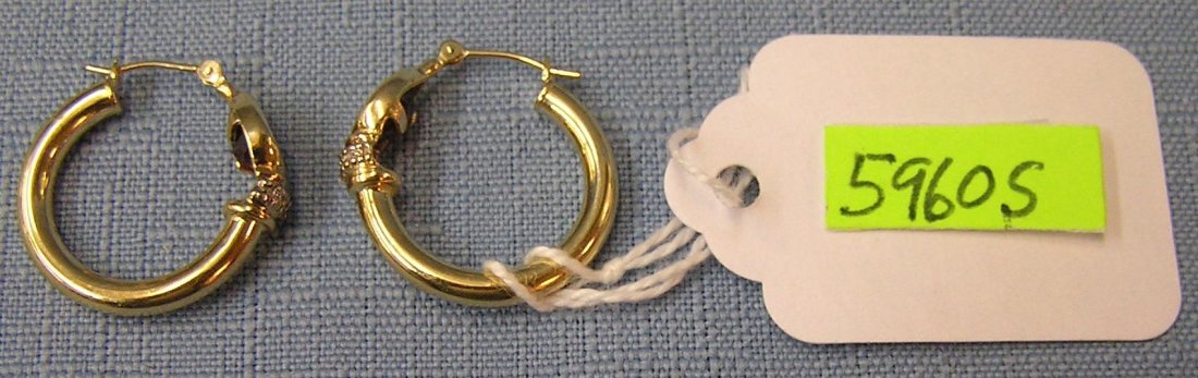 Pair of 14 kt gold earrings: Pair of 14 kt gold earrings with Diamond chip and brown colored stone $175.00-$200.00