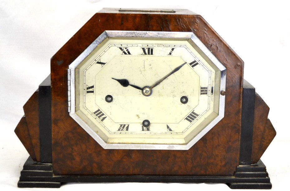 Art Deco Mantle Clock Made in England Ca. 1930: This clock looks to be in good condition for the age, the face has some scratched and looks to have some bubbling top right of clock. The clock measures 8" Tall & 12" Wide. The Plaque on the top of th