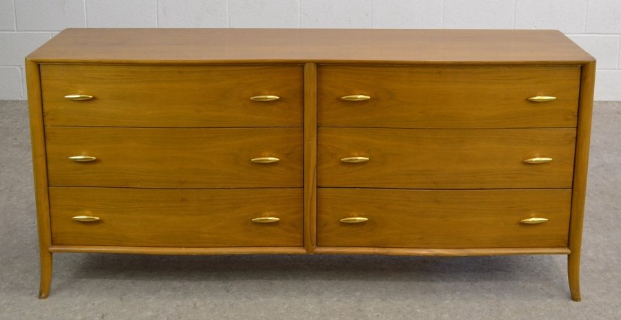 T.H. Robsjohn-Gibbings, WIDDICOMB Walnut Dresser: Slim oval handles are made of pressed porcelain with a baked on surface of 22 carat gold. Some small scratches, pictured. Measuring 32" high by 69.75" wide by 21.25" deep.