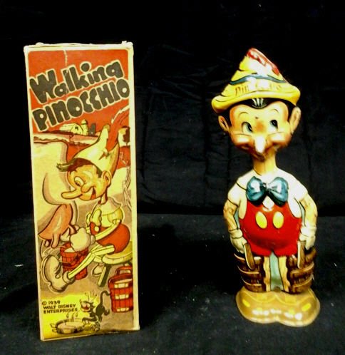 Marx Tin Wind Up Walking Pinocchio Toy, Box 1939: Copyright Walt Disney, 1939. Vintage Tin Toy Winds But Does Not Walk. Box Missing Top. Wear To Top Edge Of Box. Pinocchio Approximately 8.5 Inches Tall.