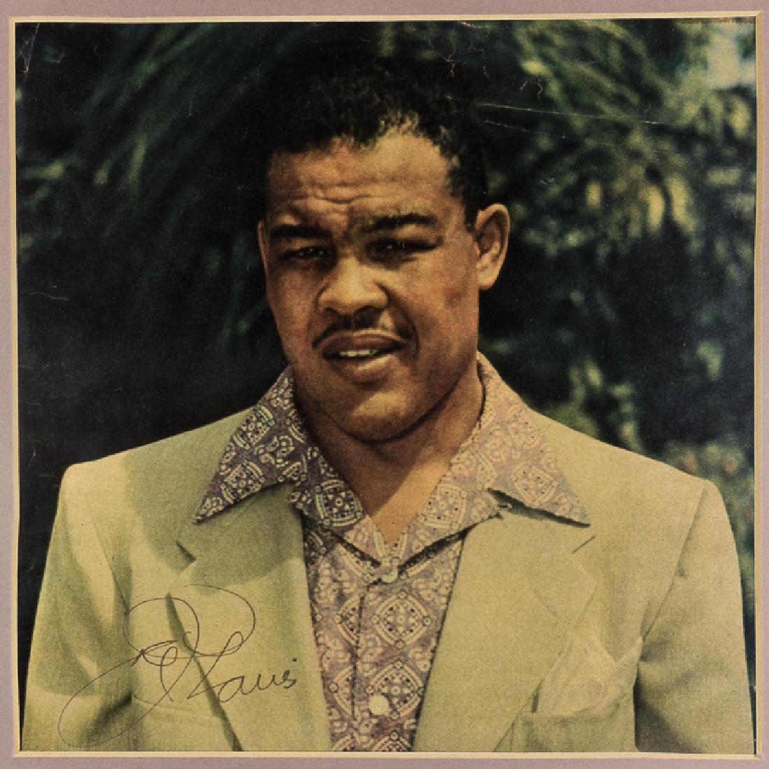 JOE LOUIS: JOE LOUIS (1914-1981) "The Brown Bomber", American heavyweight champion who defended his title 25 times, winning all bouts. S.P. 8" x 8" (sight), color, a chest, up view of the young boxer, signed at 