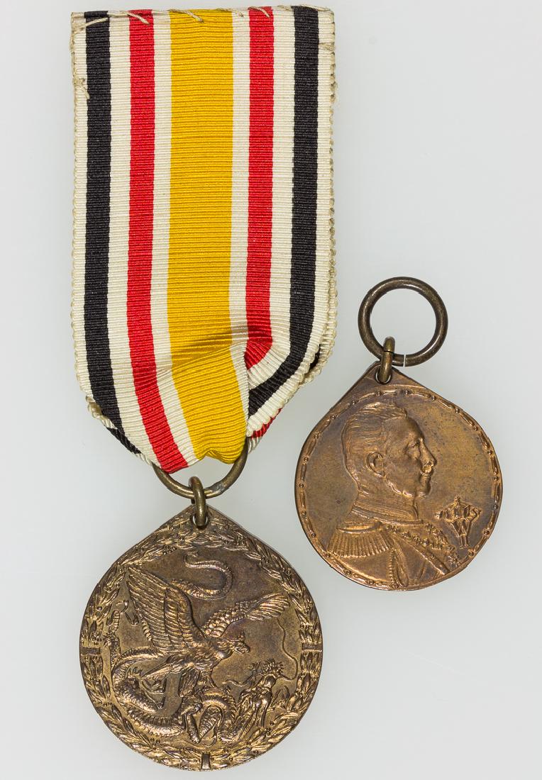 GERMAN CHINA CAMPAIGN MEDAL AND COLONIAL SERVICE MEDAL: GERMAN CHINA CAMPAIGN MEDAL AND COLONIAL SERVICE MEDAL Bronze medal with ribbon, the face with a crowned German eagle sweeping from left to right, a prostrate dragon in its claws, all within a laurel