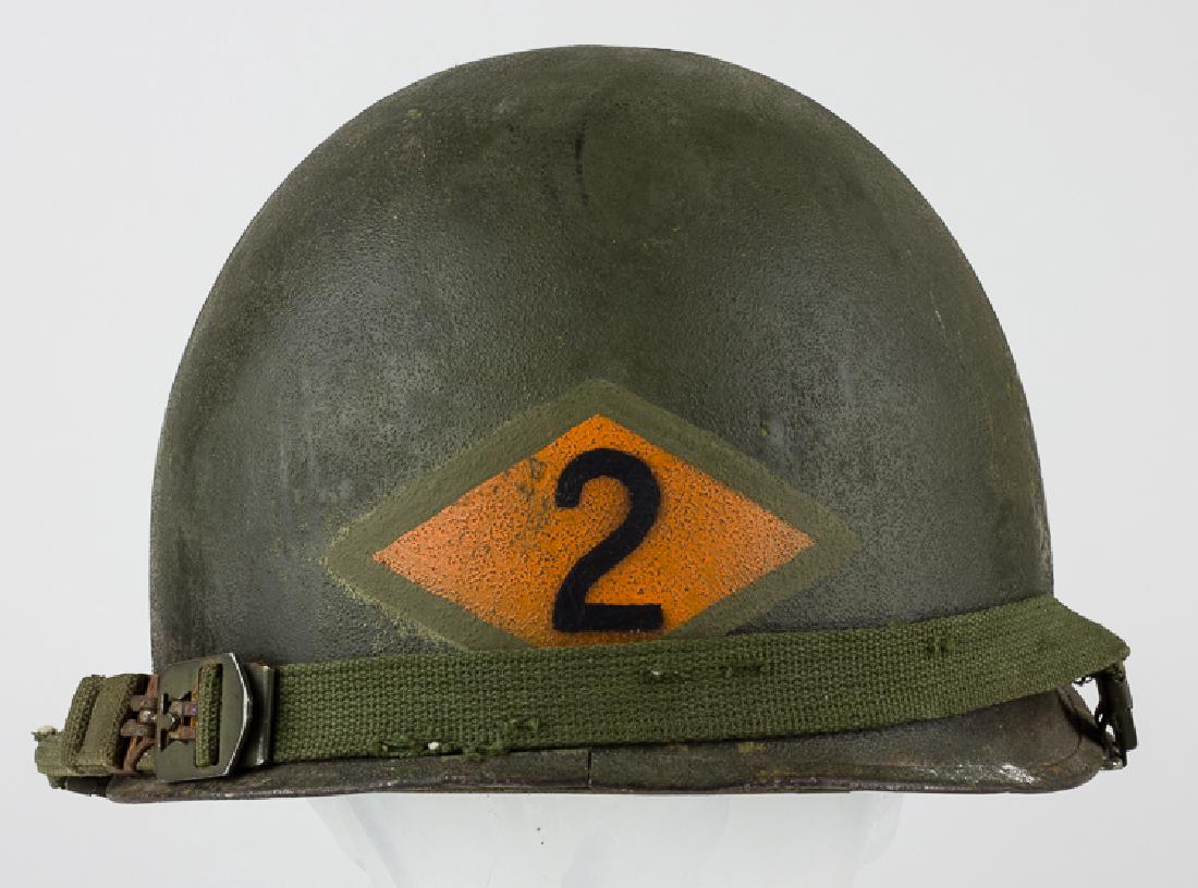 M1 HELMET WITH ARMY RANGERS INSIGNIA: M1 HELMET WITH ARMY RANGERS INSIGNIA United States Army M1 steel helmet shell and liner. The shell features swivel strap bales and a seam at the rear, metal clasps attaching the straps to the shell, a