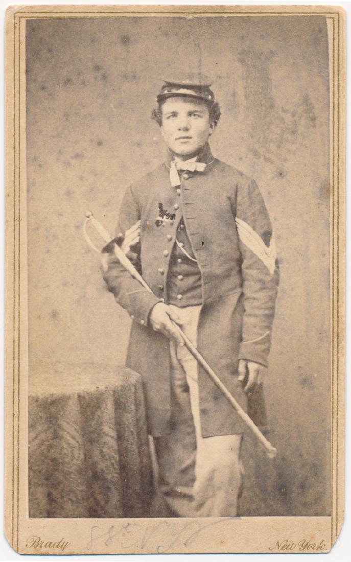 IRISH BRIGADE C.D.V.: IRISH BRIGADE C.D.V. Carte de visite photograph of a sergeant showing him three-quarter length and standing in uniform with his sword cradled in his arm. A period identification indicates that he is a