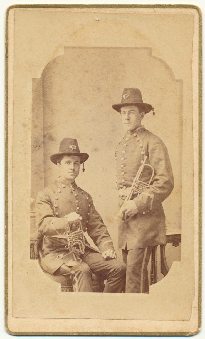 UNION MUSICIANS: UNION MUSICIANS Neat carte de visite photograph shows two uniformed Union musicians with trumpets in hand. Backstamp by Core, Lincoln [NE?].
