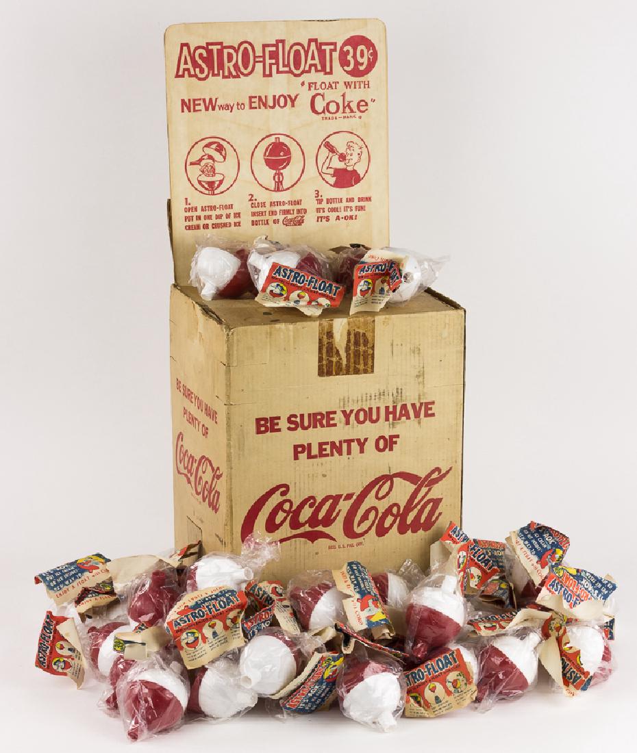 COCA-COLA "ASTRO-FLOATS" AND STORE DISPLAY: COCA-COLA "ASTRO-FLOATS" AND STORE DISPLAY Retail pack of forty 1950's-era red and white plastic Coca-Cola branded "Astro-Floats", most still contained within their plastic wrapper with paper label, a