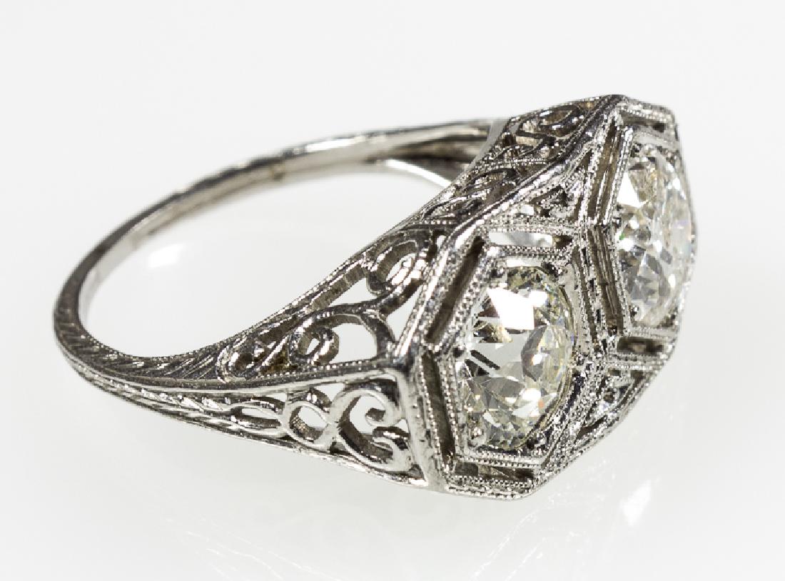 ANTIQUE EUROPEAN TWO-STONE DIAMOND RING: ANTIQUE EUROPEAN TWO-STONE DIAMOND RING Antique European platinum ring (5 1/2) bearing two approx. 1.0 carat stones. One stone is K/L color, VVS/VS with a few nicks on the girdle, the second stone K/L